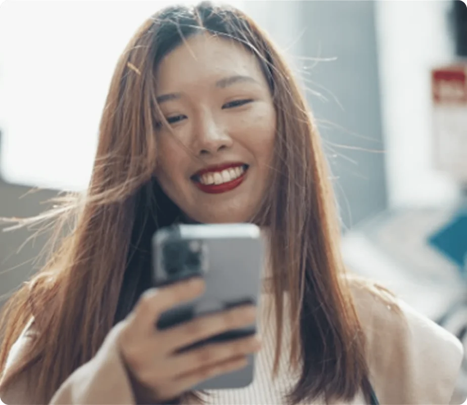 Woman checking phone to request a house cleaning quote online.