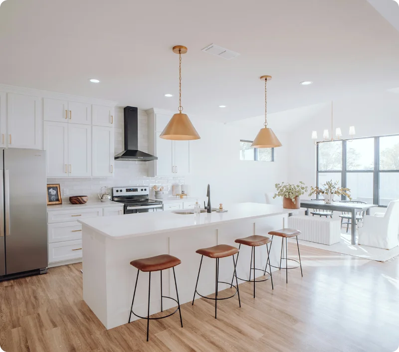 Modern white kitchen with island cleaned for a fresh finish.